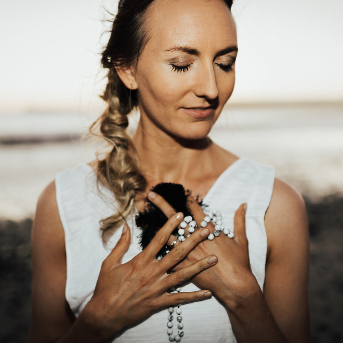 brett larkin holding prayer beads to heart