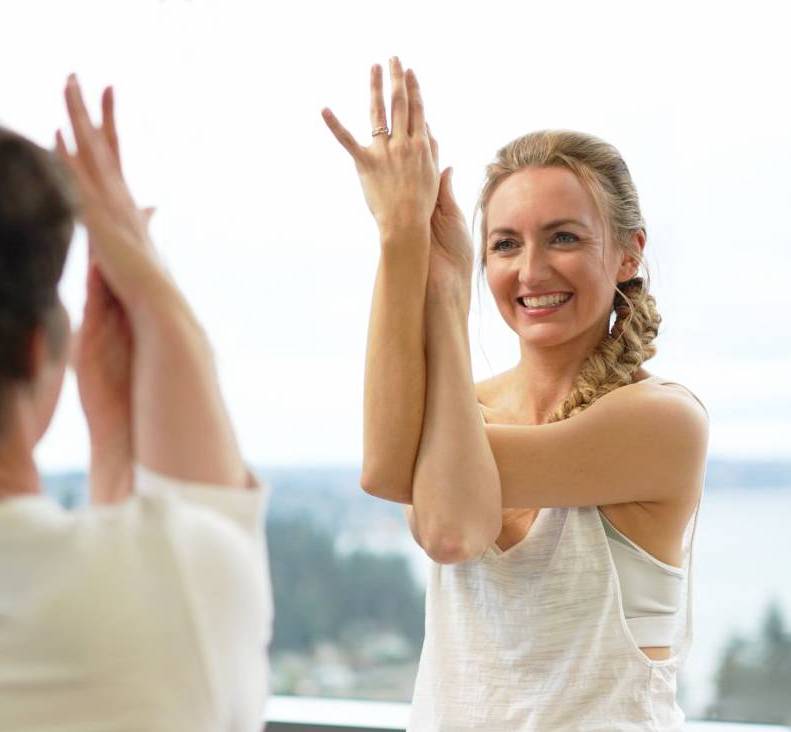 brett larkin demonstrating Garudasana with student