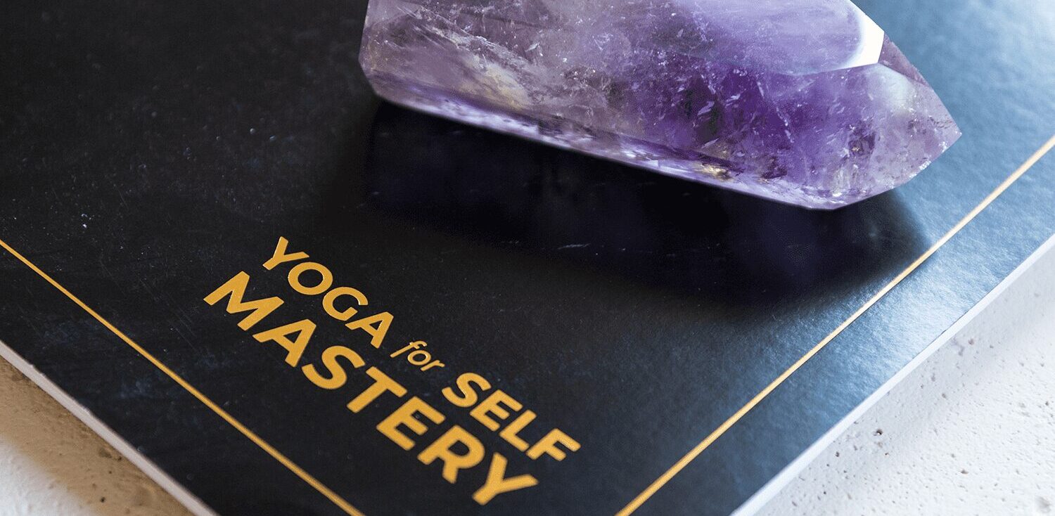 The official yoga for self mastery guidebook and journal with an amethyst crystal