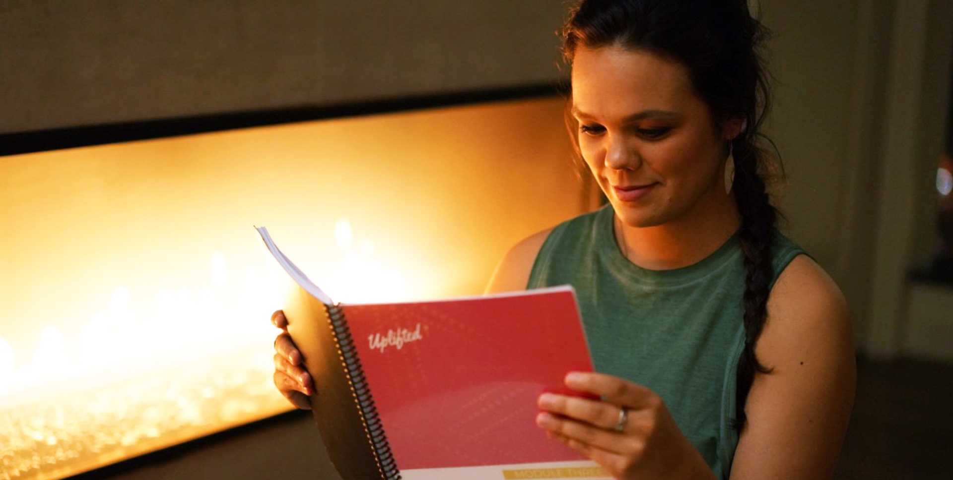 Yoga teacher lying in a supine twist on a blue yoga mat with the Yoga Life book