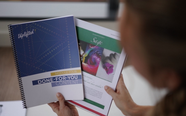 a lady having uplifted manual showing by holding in hand