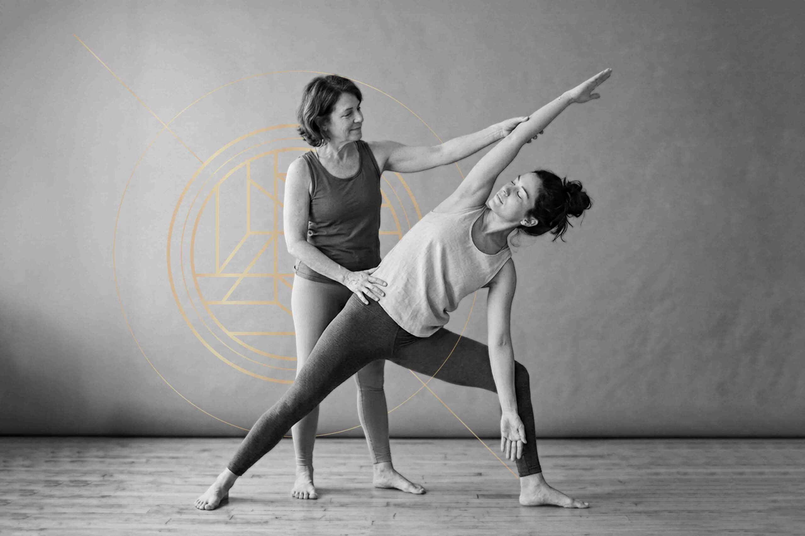 Somatic yoga training: Brett Larkin adjusting a yoga student's somatic exercise with a yoga block