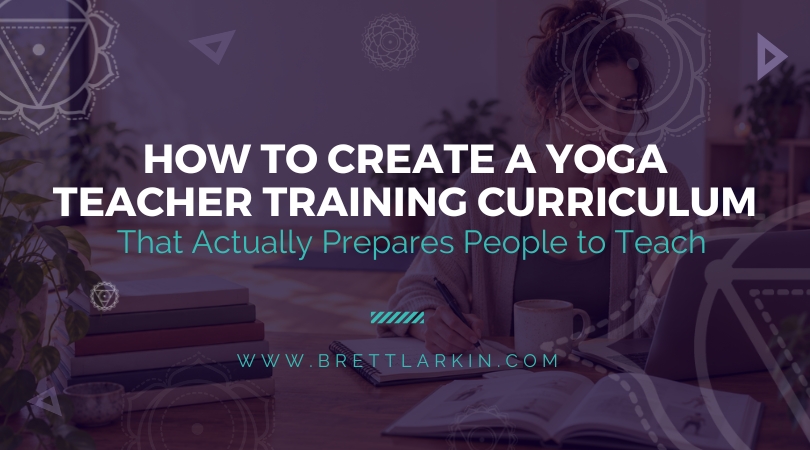 Yoga teacher creating a yoga teacher training curriculum at a desk with books, notes, and a laptop.